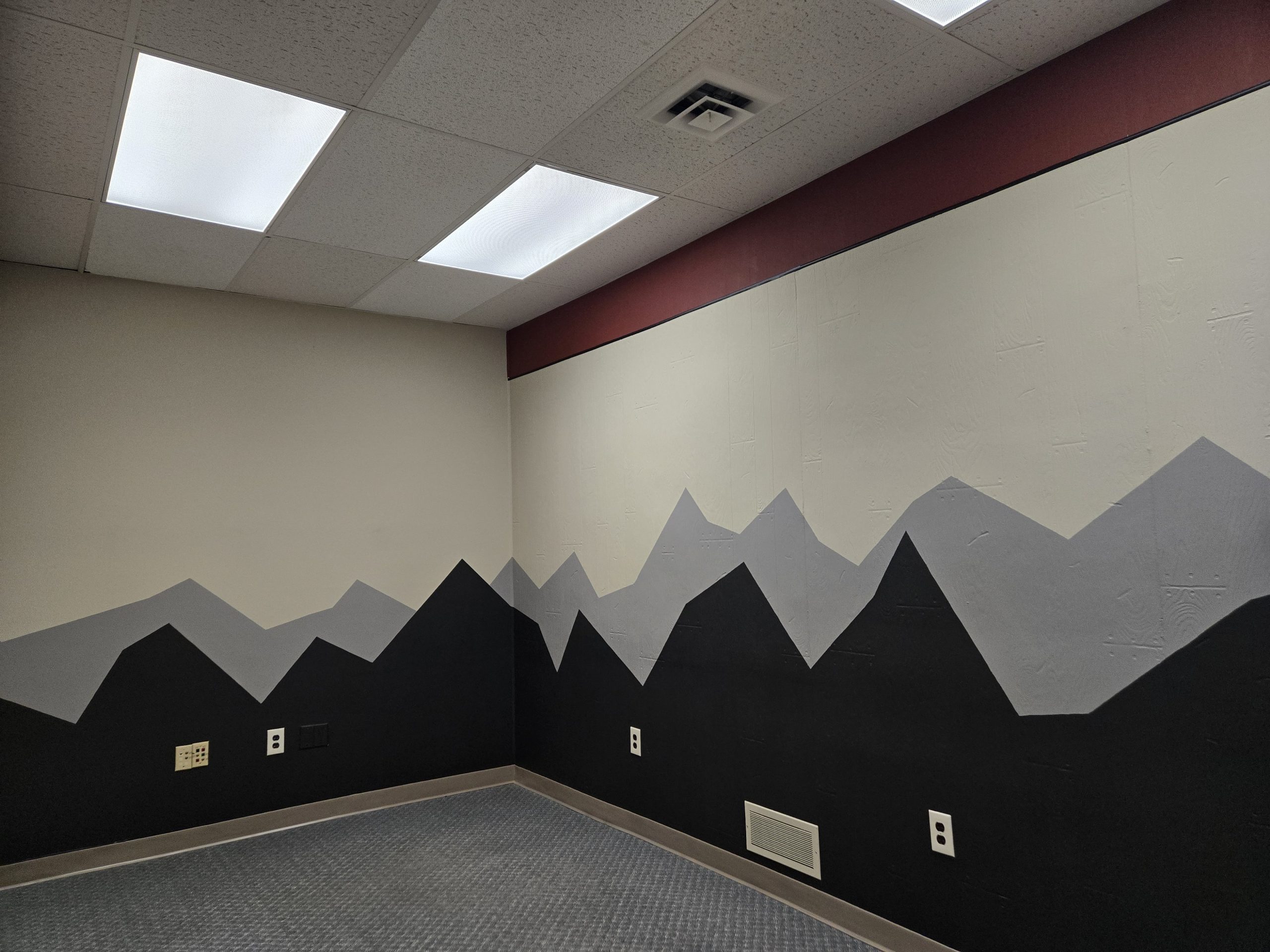 Suite 533 feature wall with geometric design beneath skylight panels. large commercial office space in Butte MT